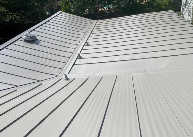 Solar attic fan installed on a metal roof for Roof Ventilation in Northport